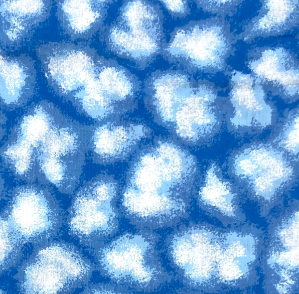 White cumulus clouds on a blue background