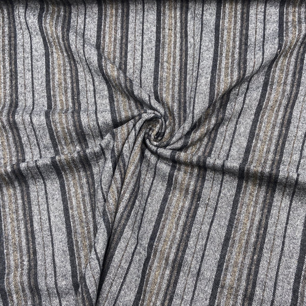 A close-up of a black and grey striped fabric scrunched into a swirl design.