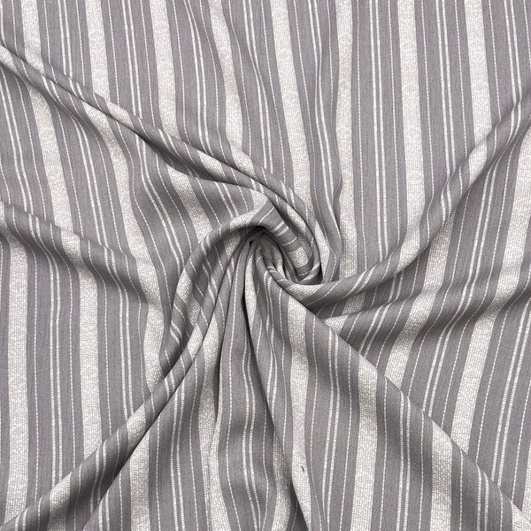 A gray striped rayon fabric with a crinkly texture that is scrunched in the middle in a swirl to show the fabric's texture and movement.