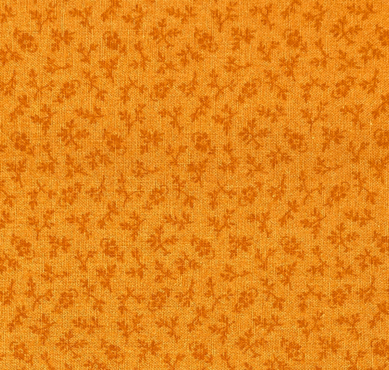 Dark orange sprigs, branches and flowers on a medium orange background.