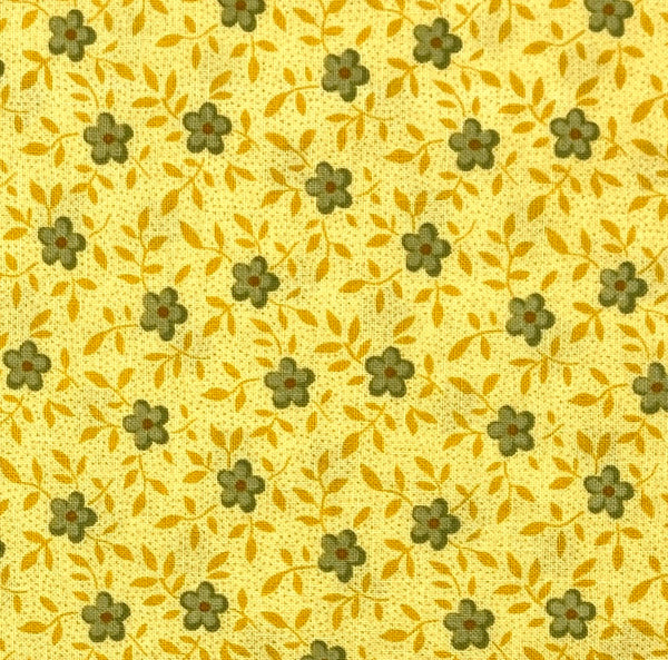 Little green flowers with dark yellow vines and tiny polka dots on a light yellow background.