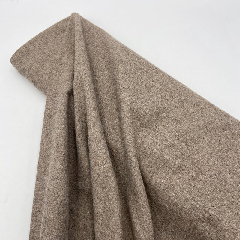 A bolt of warm grey wool fabric.