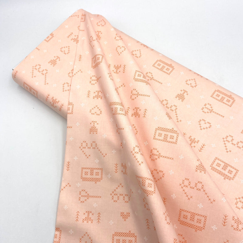 peachy pink cross stitch print fabric for quilting