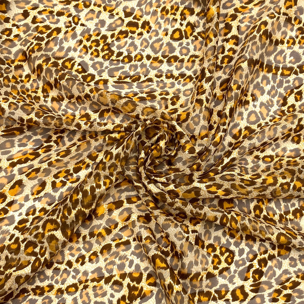 An animal-print chiffon fabric with warm brown and orange hues. 