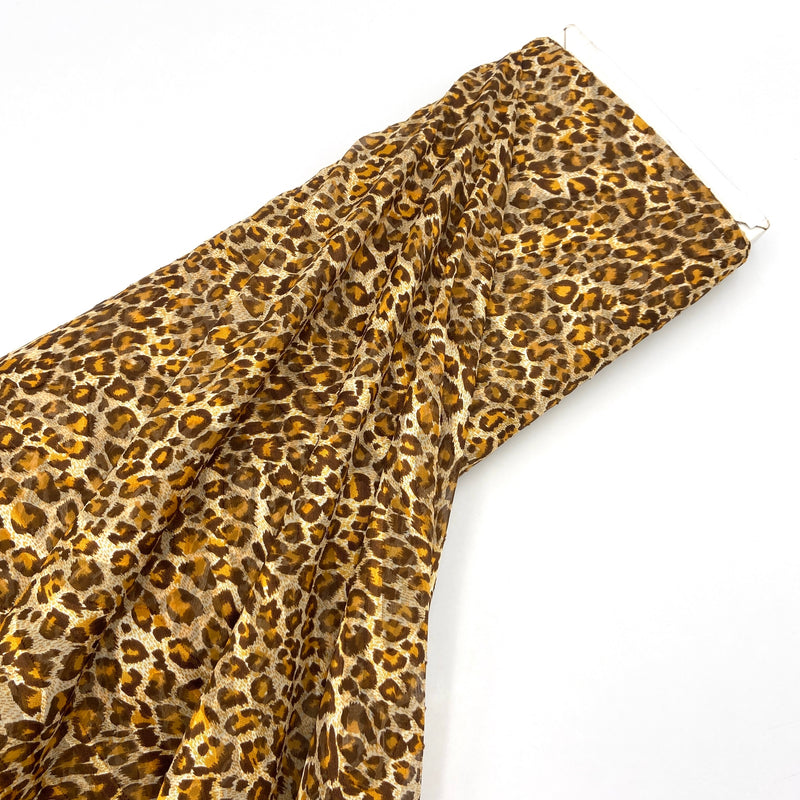 A bolt of chiffon fabric with a warm brown cheetah or leopard print. 